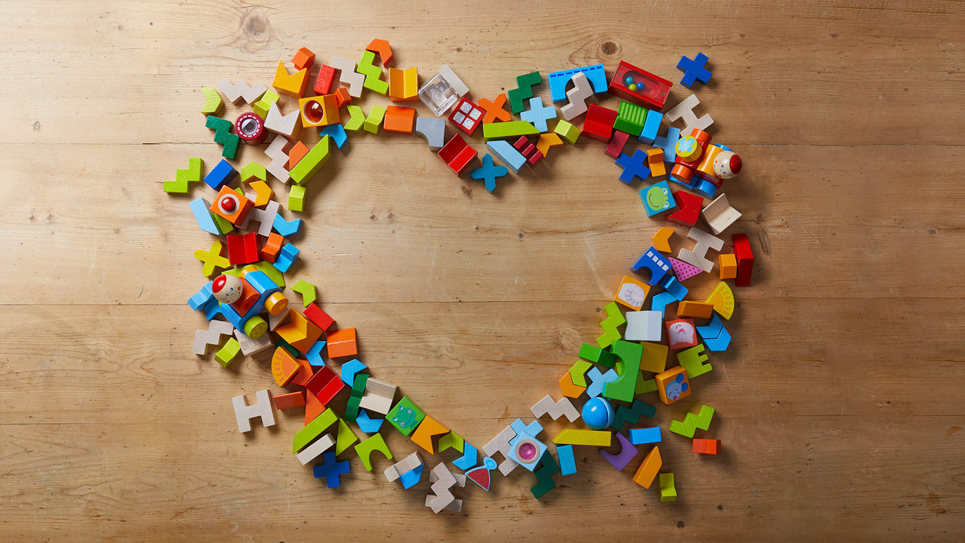 HABA multicolored wooden blocks on a wooden background