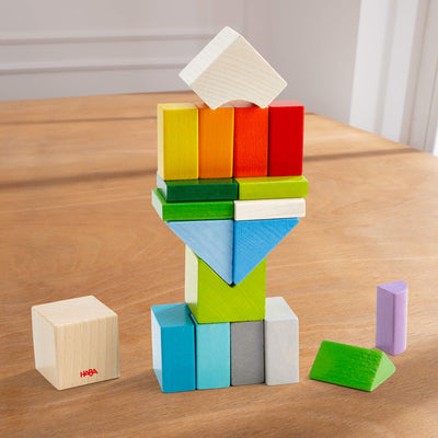 Chromatix colorful wooden blocks set stacked on a wooden surface.