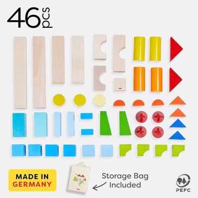 46 colorful wooden building blocks in various shapes, including cylinders, rectangles, and triangles, with a storage bag. Made in Germany.