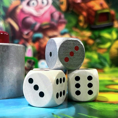 Close-up of three stacked dice on a colorful board game.