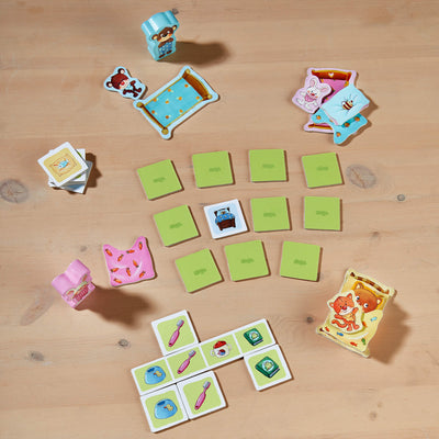 My Very First Games - Off To Bed! setup on a wooden table featuring colorful cards and characters arranged playfully.