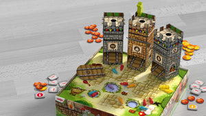 Knuckling Knights Board game with three cardboard towers on a detailed cobblestone board, featuring game pieces, coins, and tiles.