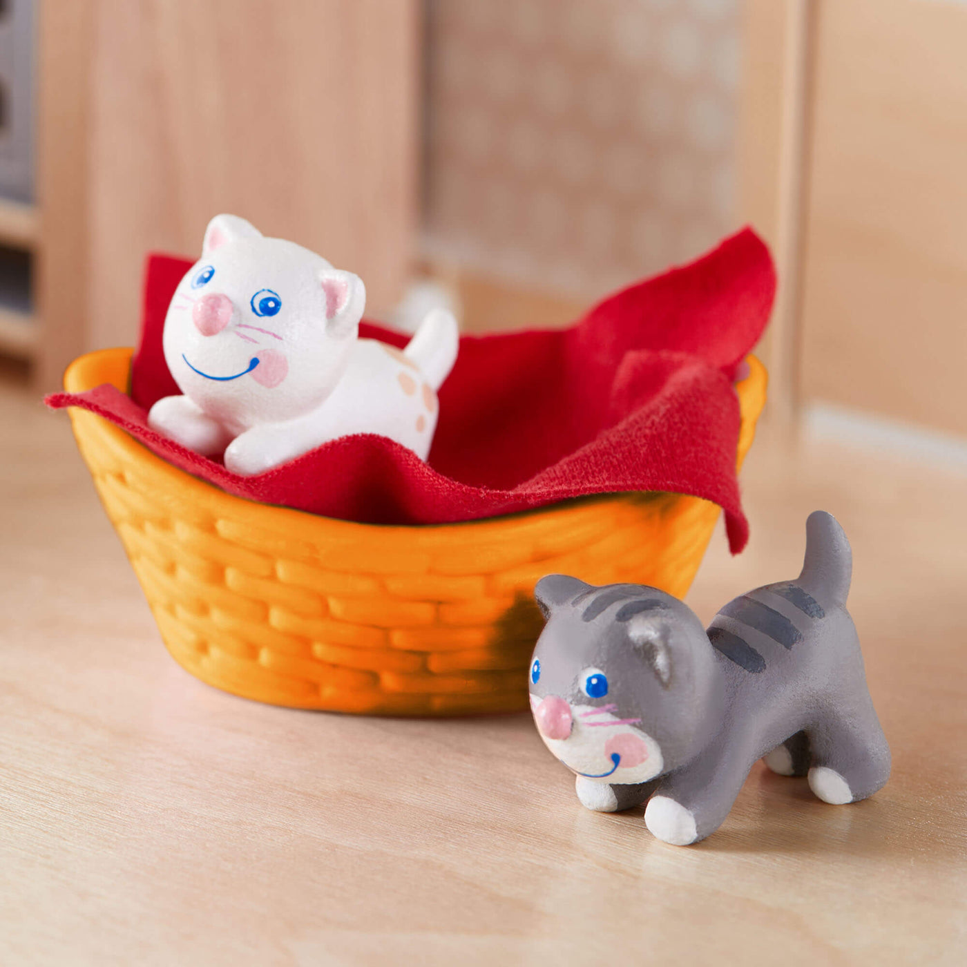 HABA Little Friends Kittens Play Set with orange basket and red blanket on wooden table