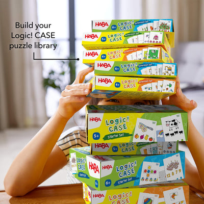 Build your Logic! CASE puzzle library! Stack of Logic! CASE game boxes on wooden table