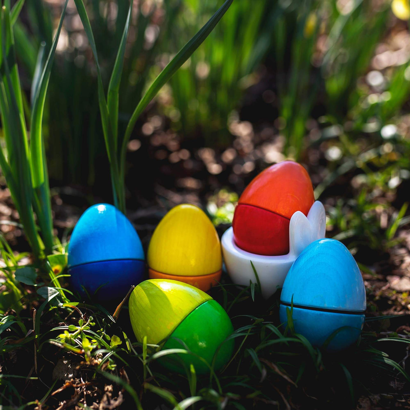 A set of wooden Musical Eggs sitting on the grass