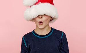 Child with Santa hat pulled over his eyes