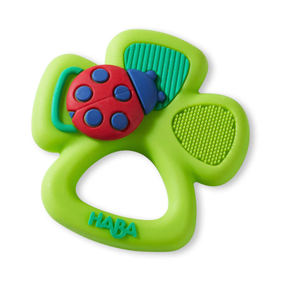 Lime green four-leaf clover teething toy with a red and blue ladybug embellishment.